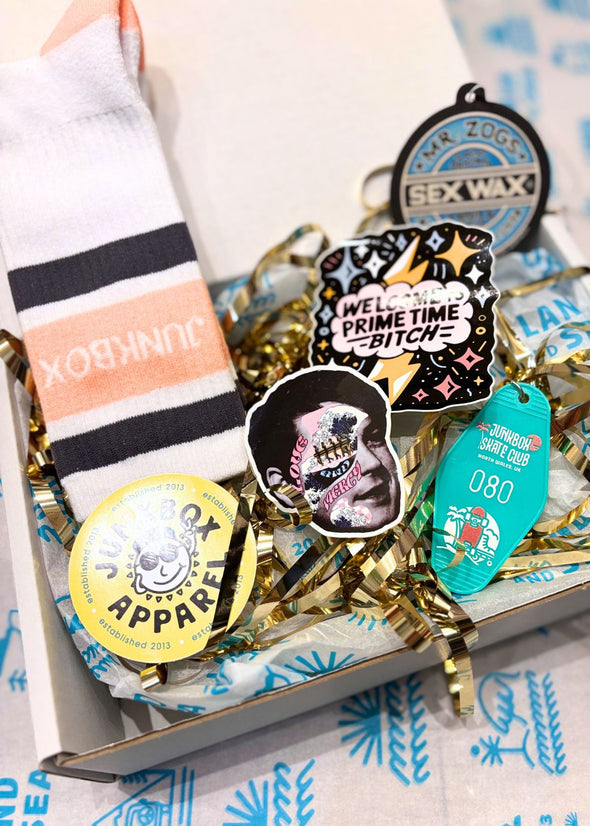 Collection of stickers and socks with text and graphics on a box