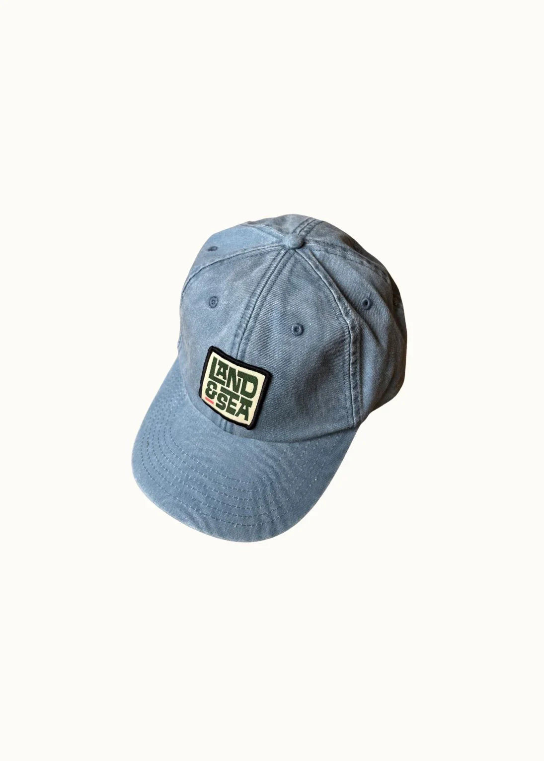 Blue denim cap with a logo on a white background